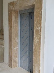elevator's doors framed in marble 